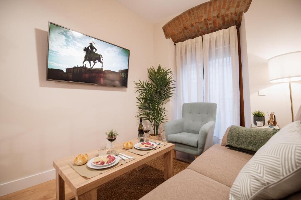 a living room with a couch and a table and a chair at Casa Cancho Trujillo in Trujillo