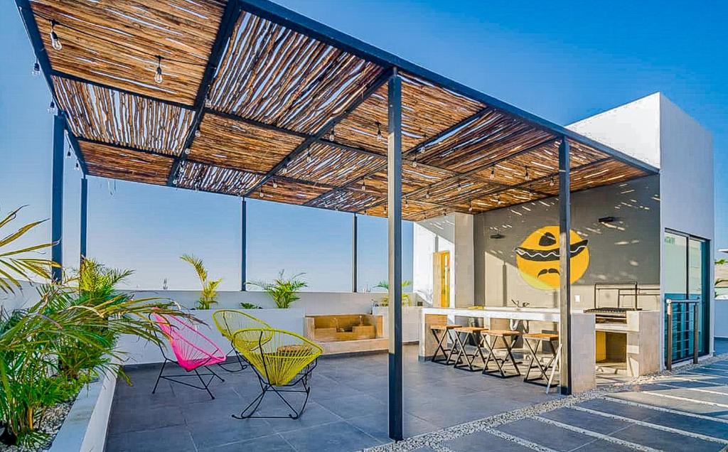 a house with a patio with a table and chairs at dewl estudios : El Mexicano in Playa del Carmen