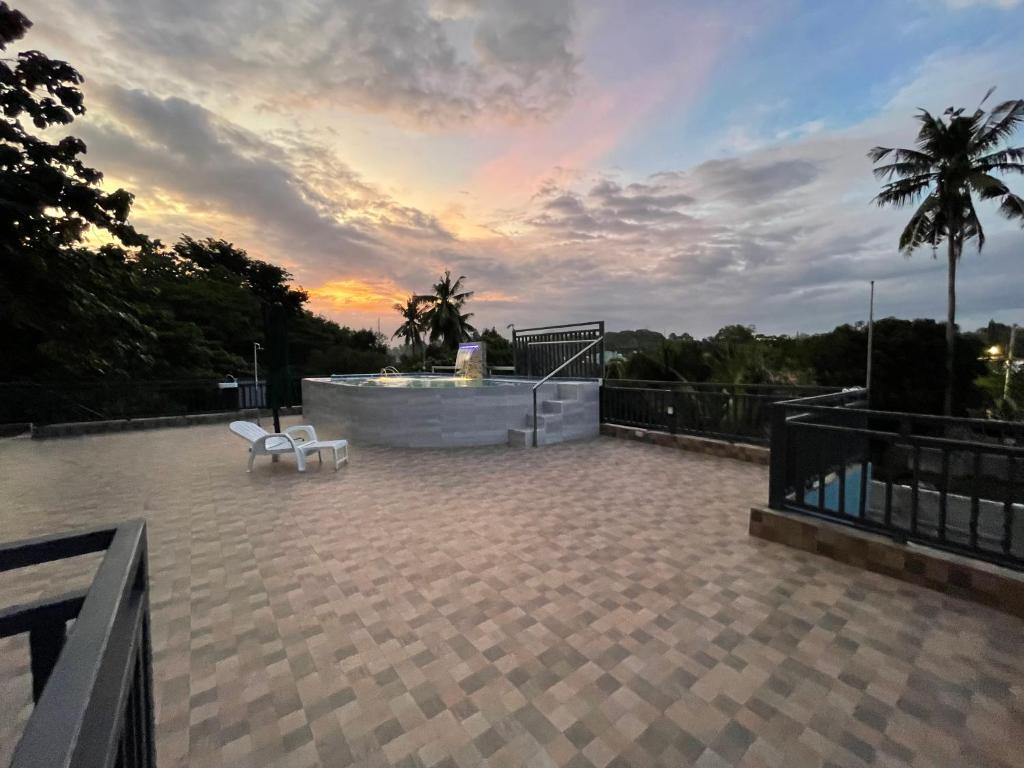 a patio with a fountain and a sunset in the background at Charming Apartelle with Swimming Pool -Exclusive in Davao City