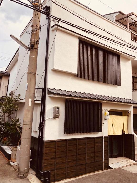 a house with a gate and a garage at Art House in Osaka