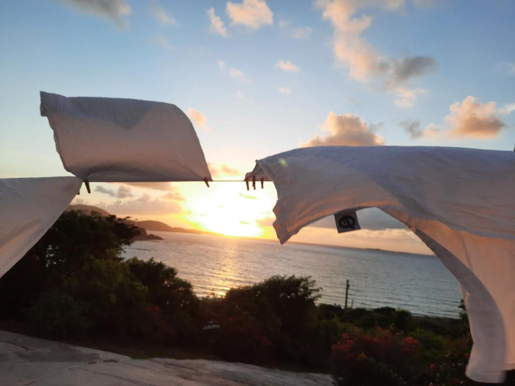 a view of the sunset from a patio with the ocean at Virgin Islands Campground in Water Island