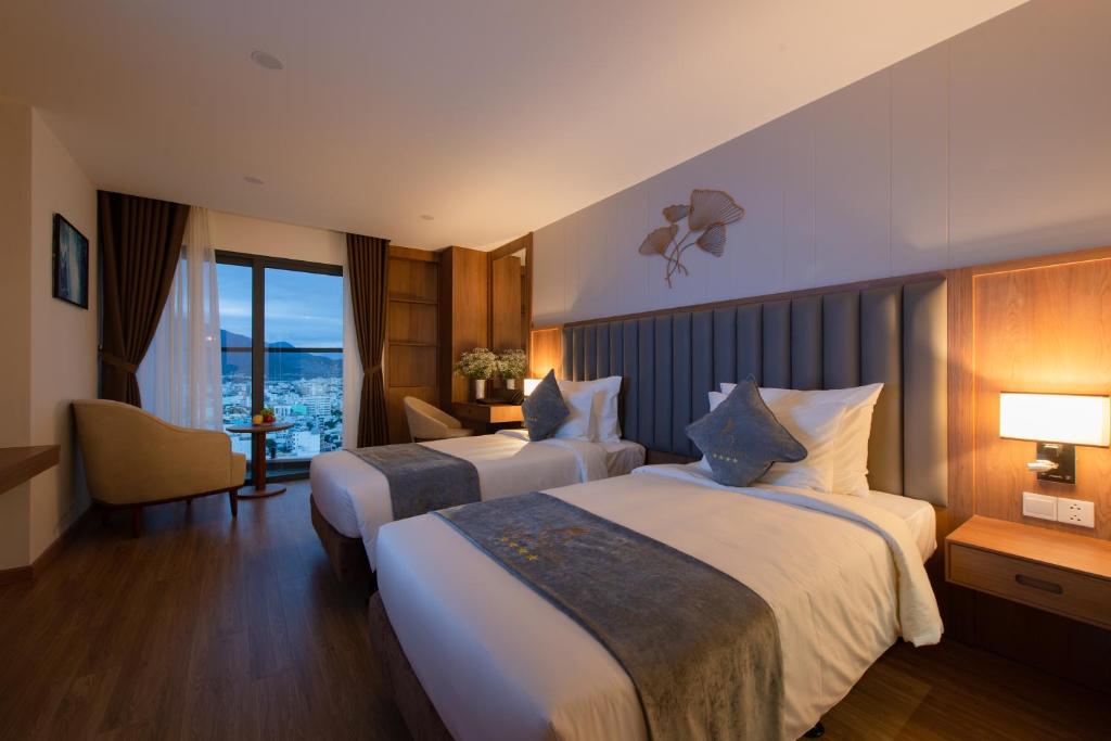 Postel nebo postele na pokoji v ubytování Grand Gosia Hotel