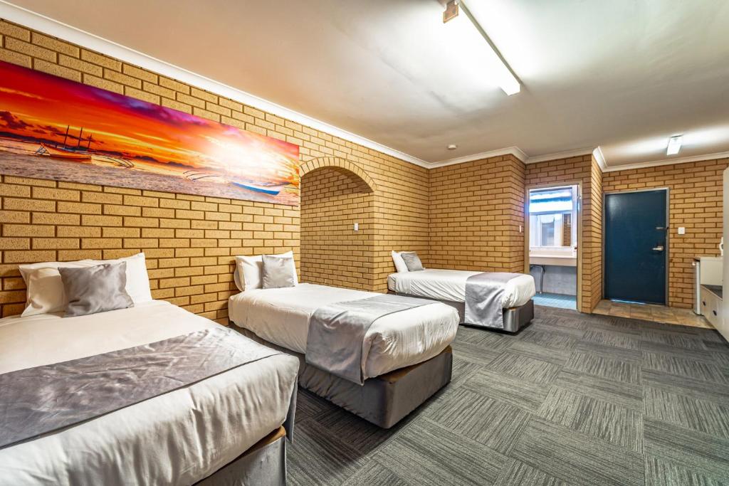 A bed or beds in a room at Carnarvon Motel