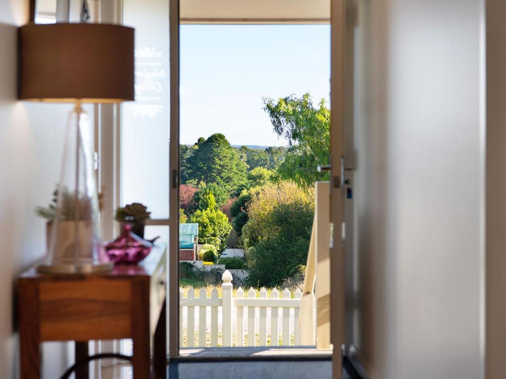 a view of a garden from a house through a door at Wayfarer Cottage in Daylesford