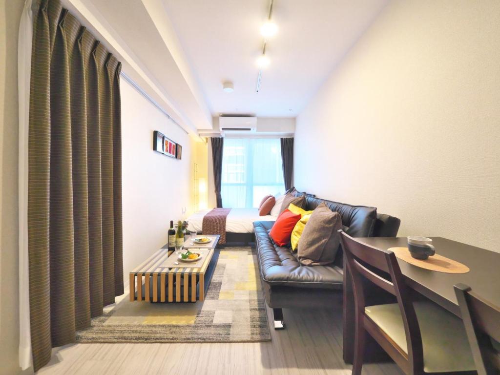 a living room with a couch and a table at Fuchsia - Vacation STAY 28744v in Nagoya