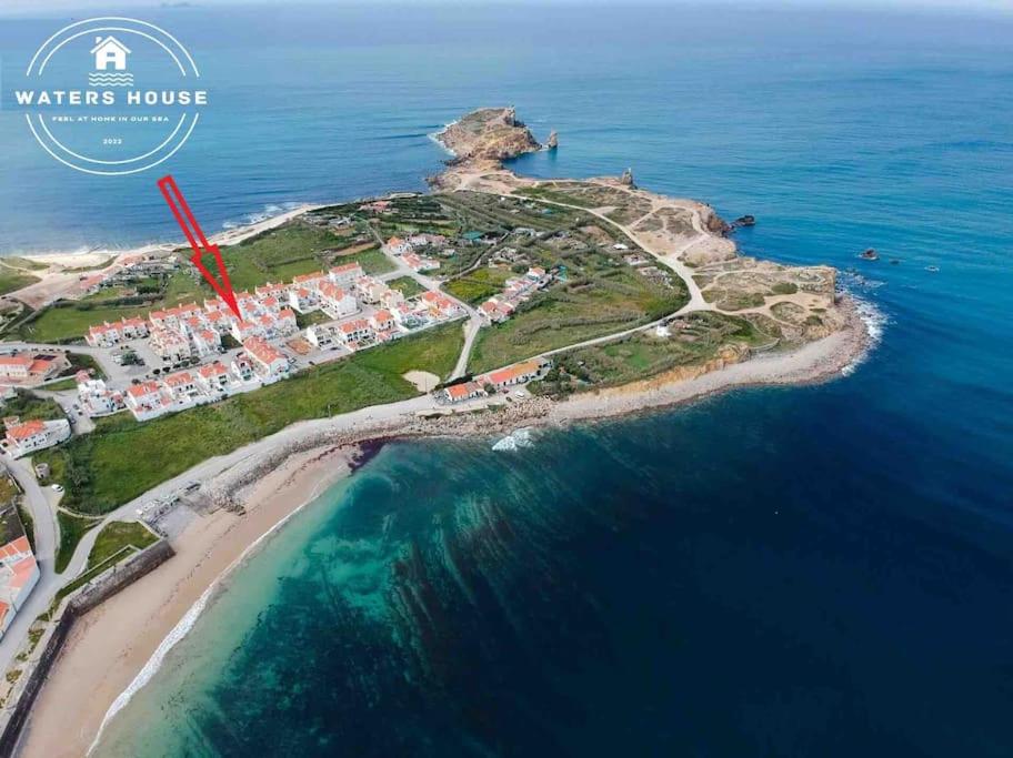 an island in the ocean with a red arrow at WATERS HOUSE STUDIO in Peniche