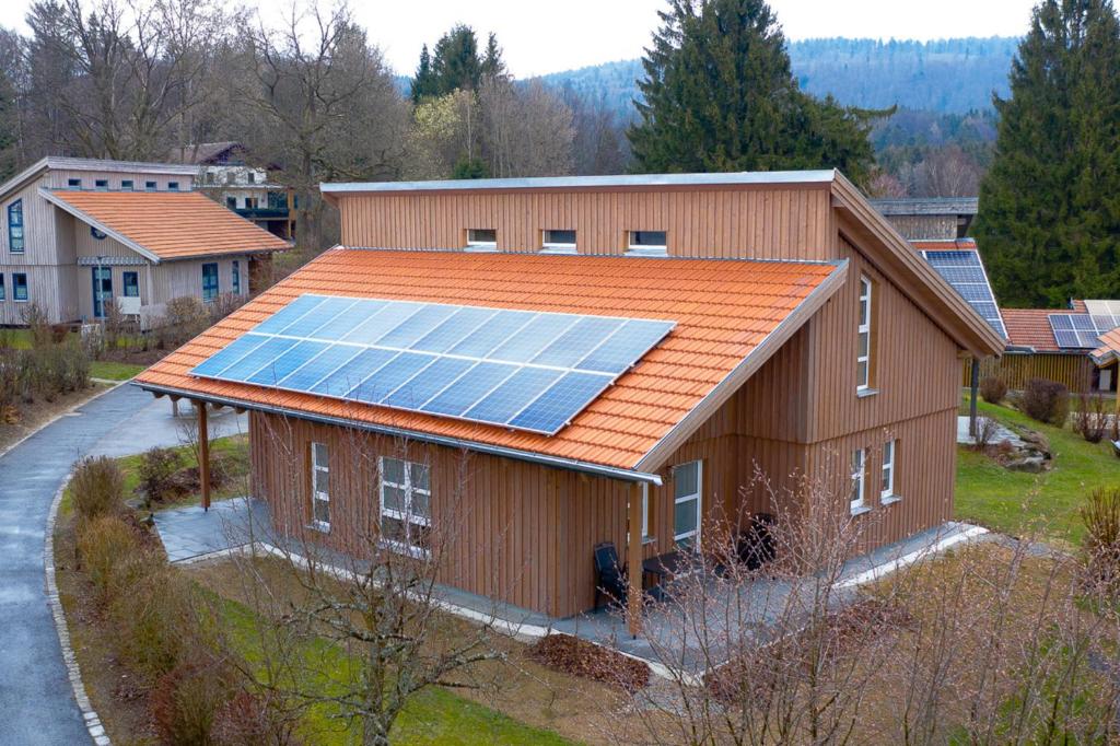 a house with solar panels on the roof at Ferienhaus Nr 17B2, Feriendorf Hagbügerl, Bayr Wald in Waldmünchen