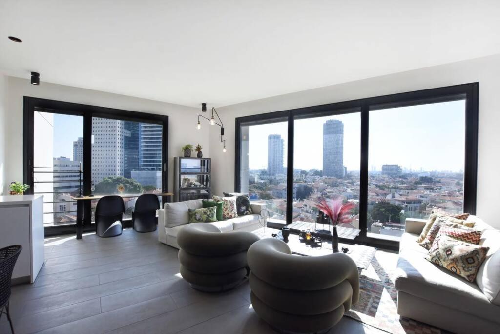 a living room with a view of a city at Amazing 2BR Condo with Sea View by HolyGuest in Tel Aviv