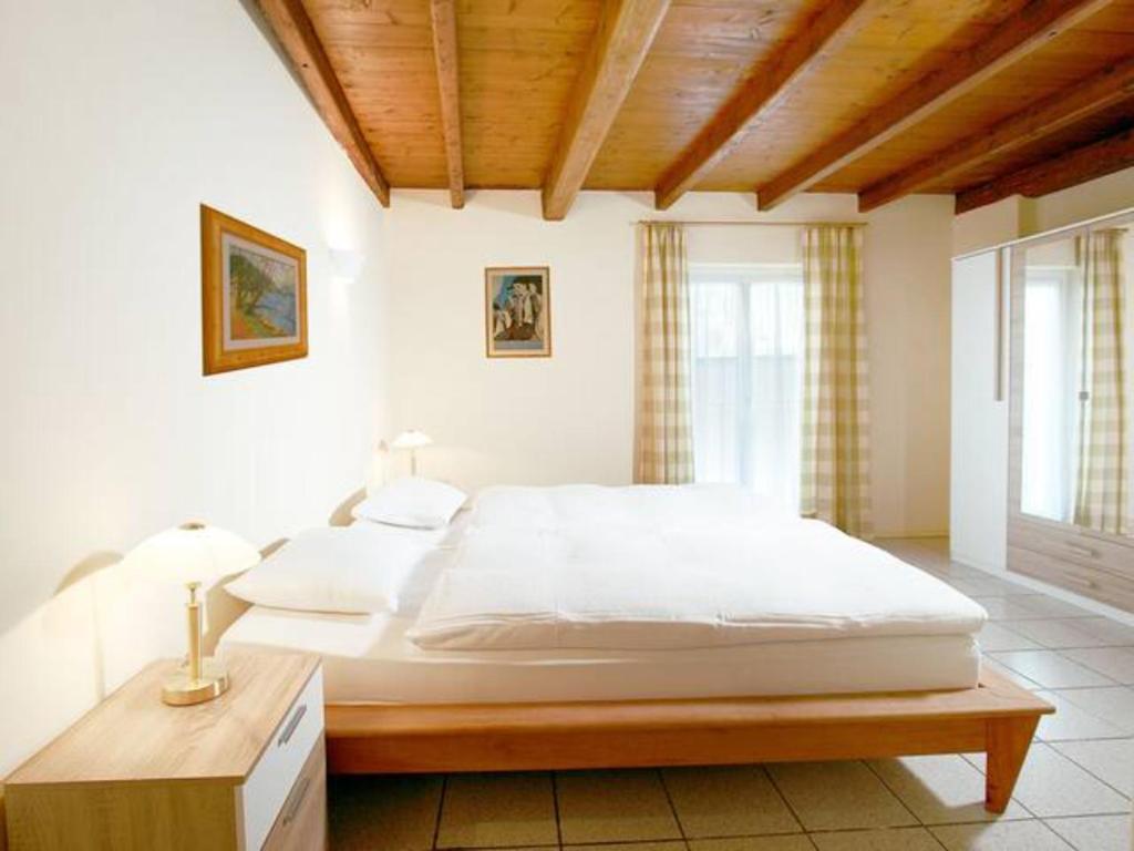 A bed or beds in a room at Depandance Garni Golf
