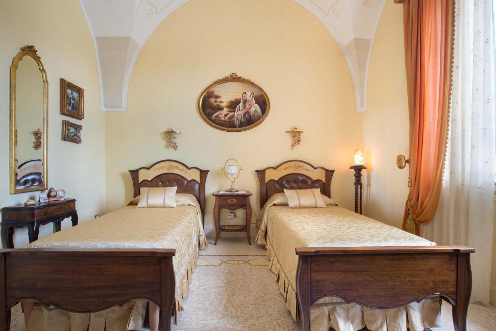 Łóżko lub łóżka w pokoju w obiekcie Villa Nicrys by Perle di Puglia