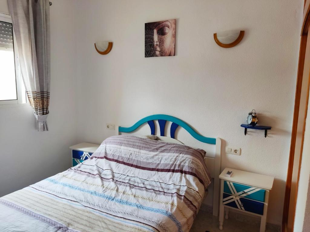 a small bedroom with a bed and two tables at Casa Joleen 1 in Villamartin