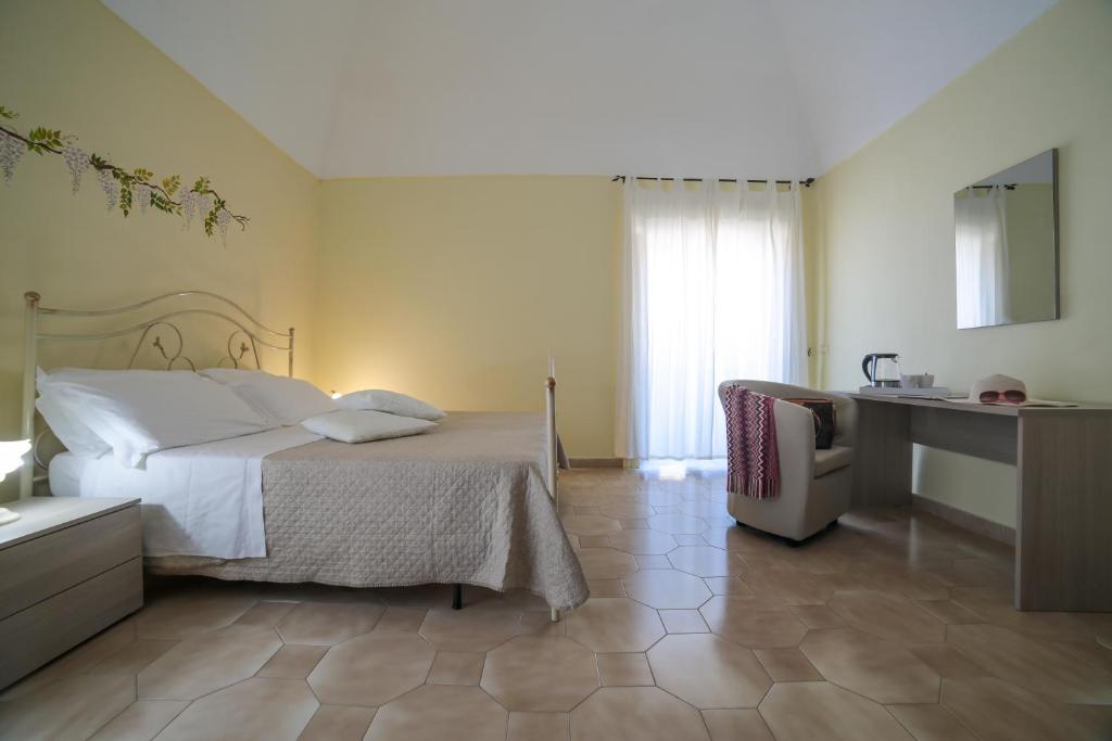 a hotel room with a bed and a desk and a desk at Flowers apartments & rooms in Meta