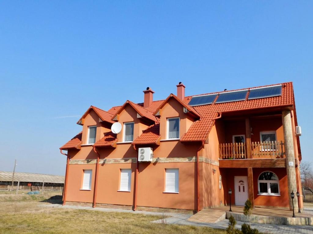 ein Haus mit Sonnenkollektor auf dem Dach in der Unterkunft Csetáj Vendégház in Hajós