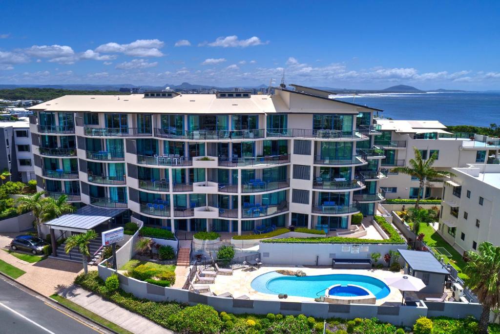 an aerial view of a large apartment building with a swimming pool at Alexandra on the Pacific in Mooloolaba