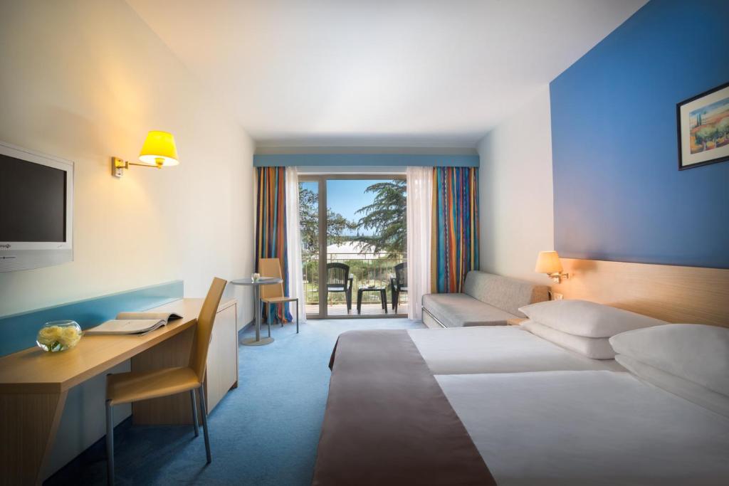 Krevet ili kreveti u jedinici u okviru objekta Remisens Hotel LUCIJA