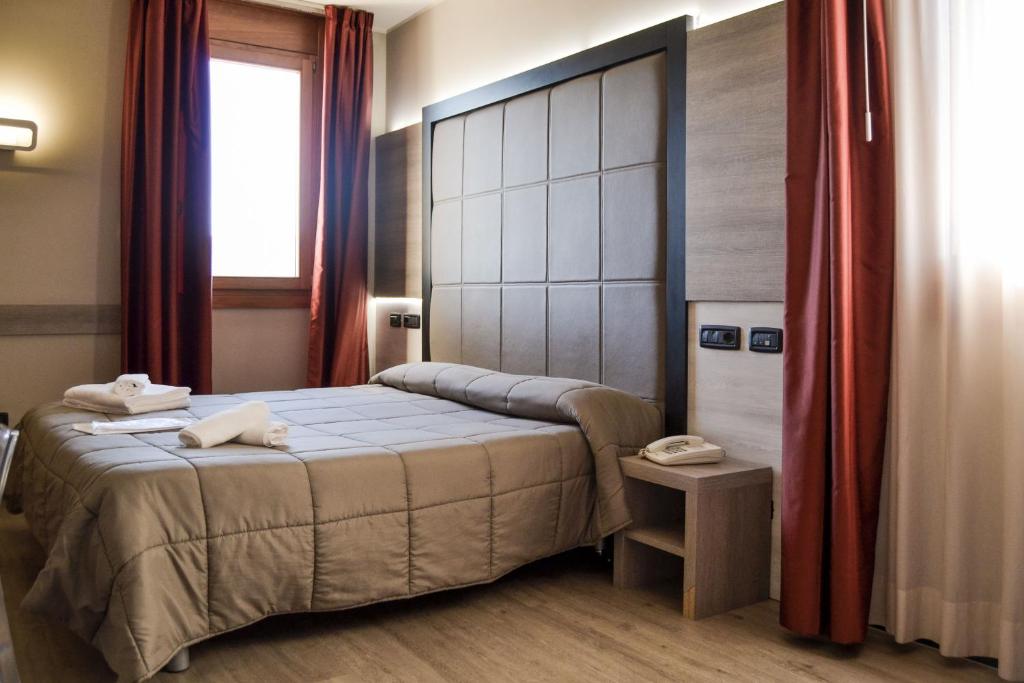 Postel nebo postele na pokoji v ubytování Planet Hotel