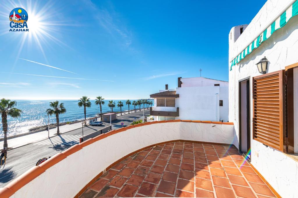 a view of the beach from the balcony of a house at Apartamentos Ibiza Casa Azahar in Alcossebre