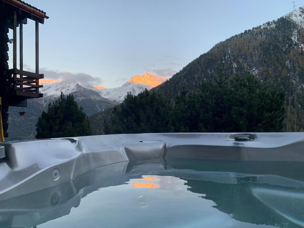 a bath tub with a view of a mountain at Rafaches in Grimentz