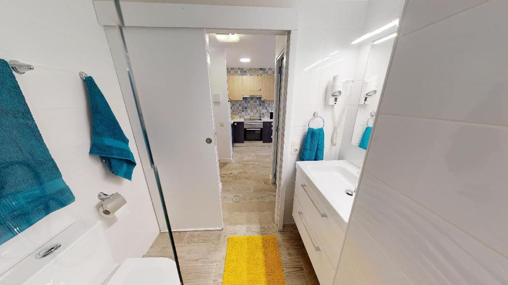a bathroom with a shower and a sink and a mirror at Apartamentos Eldorado in Lloret de Mar