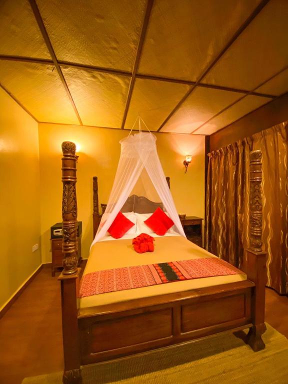 a bedroom with a bed with a canopy at Ombak Dive Resort Perhentian Island in Perhentian Islands