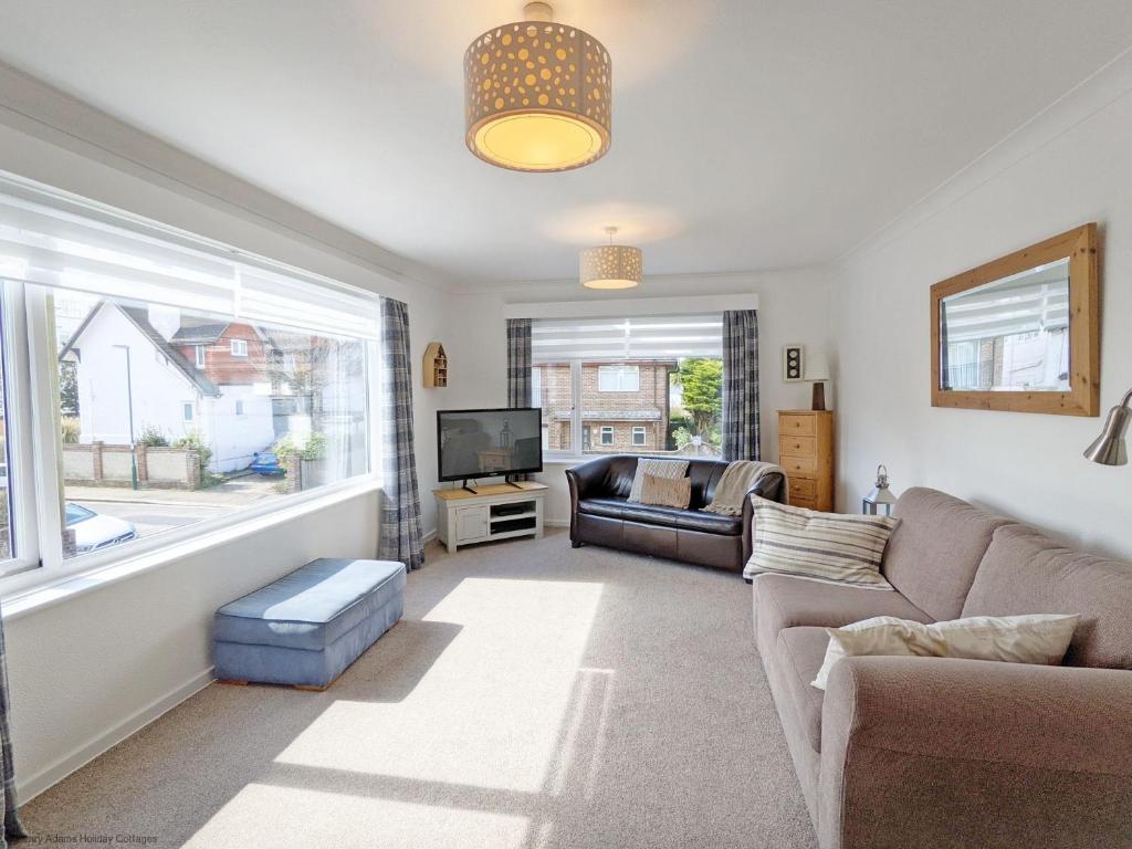 a living room with a couch and a tv at The Lookout - Bognor Regis in Bognor Regis