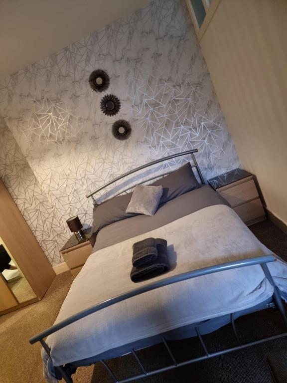 a bedroom with a large bed with a wall at Grampian Hotel in Keith