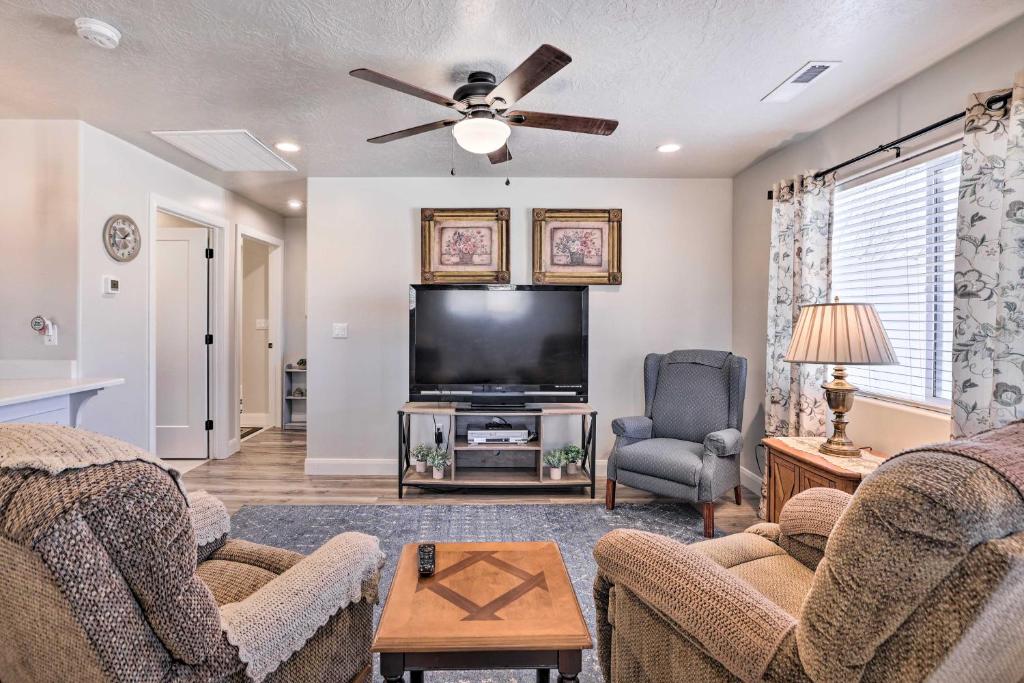 a living room with two couches and a flat screen tv at Central Kanab Apartment with Updated Interior! in Kanab