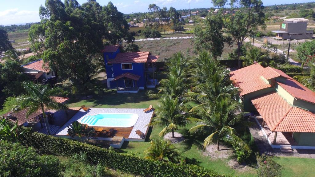 an aerial view of a house with a swimming pool and palm trees at Mangaba Village in Barra Grande