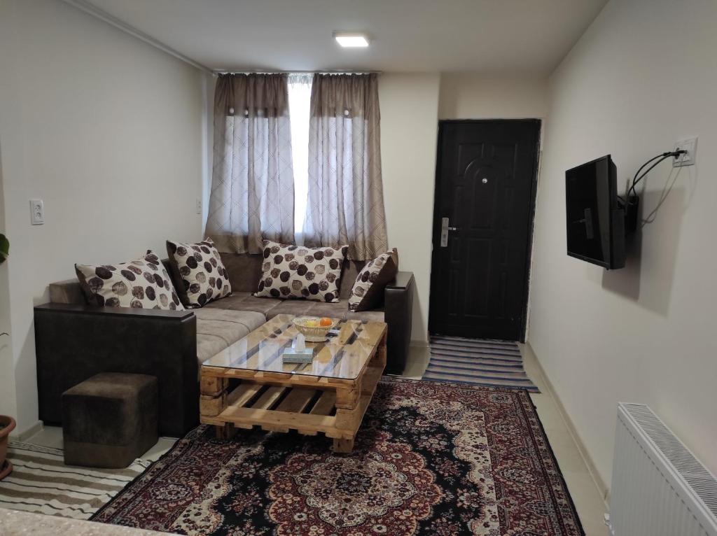 a living room with a couch and a coffee table at Julia's Place - Apartment, Garden & BBQ in Vagharshapat