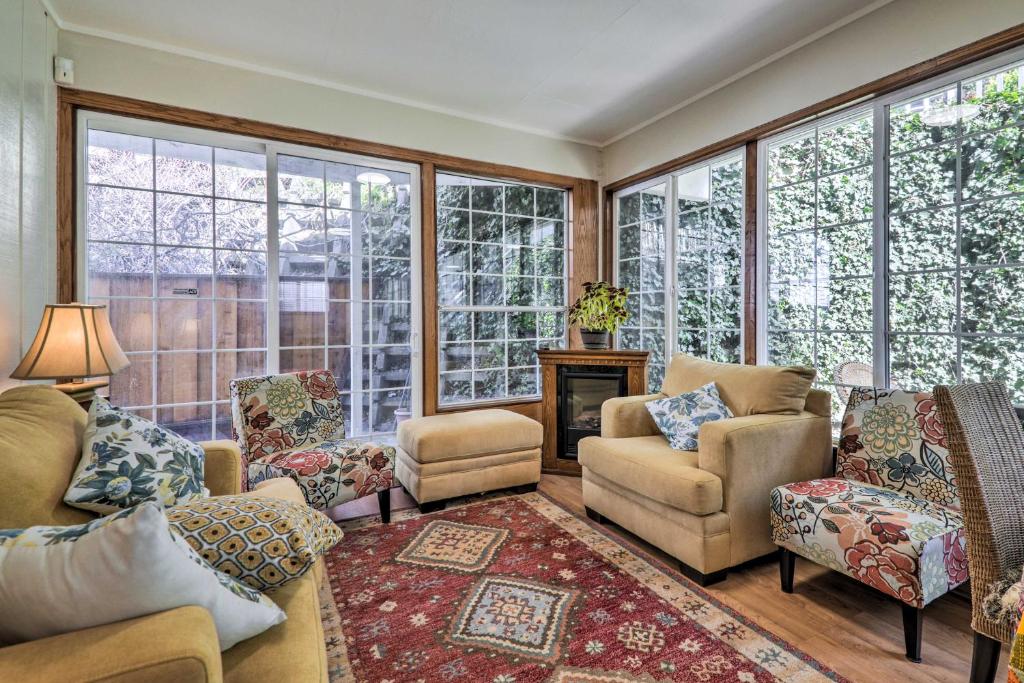 a living room with a lot of windows at Peaceful Oakland Oasis with Shared Yard! in Oakland