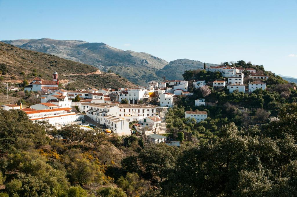 a village on a hill with white houses at La Casita de Atajate in Atajate
