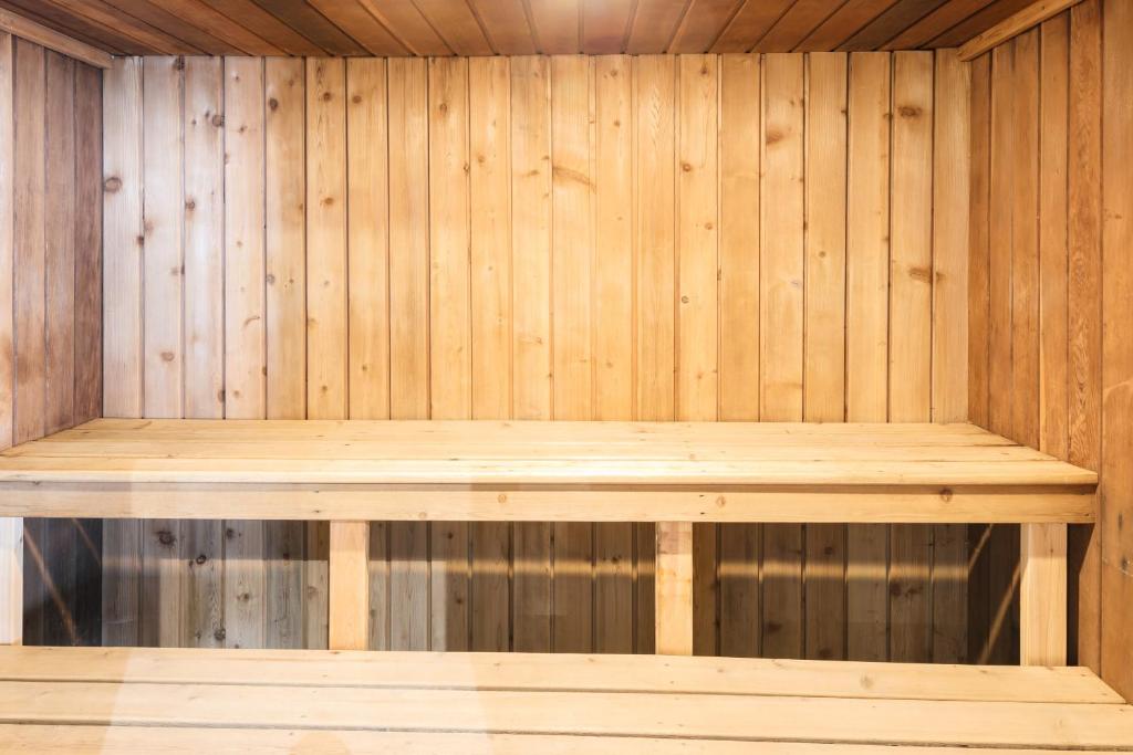 a wooden sauna with a wooden bench in it at Rodd Charlottetown in Charlottetown