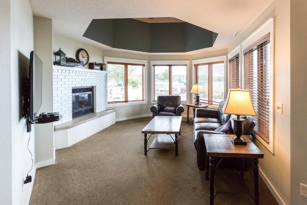 a living room with a couch and a fireplace at Bay Colony- Unit 764 - Lower in Nisswa