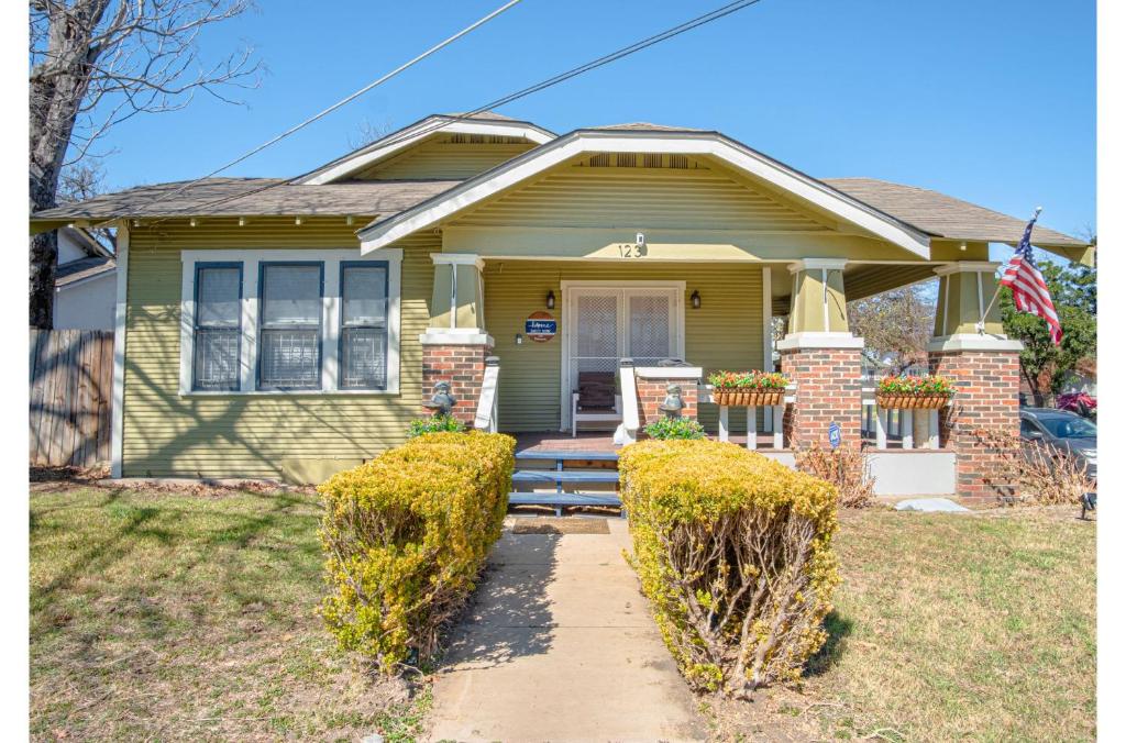 a house with an american flag in front of it at Stunning 3 BR Home Near DT Alamodome - Riverwalk in San Antonio