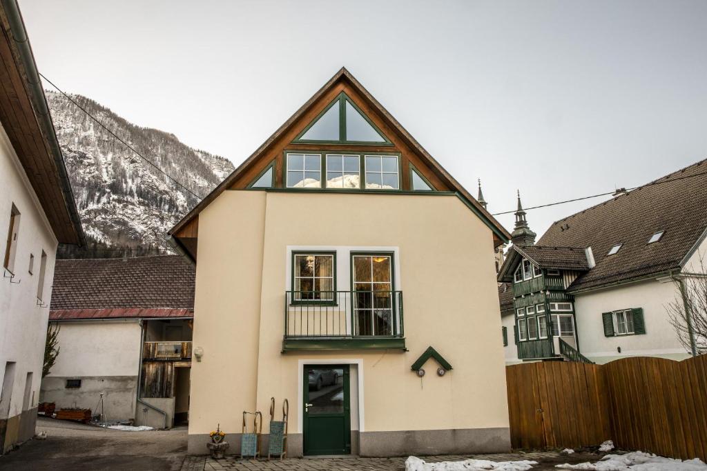 a white house with a green door at Ferienhof Pacher in Spital am Pyhrn