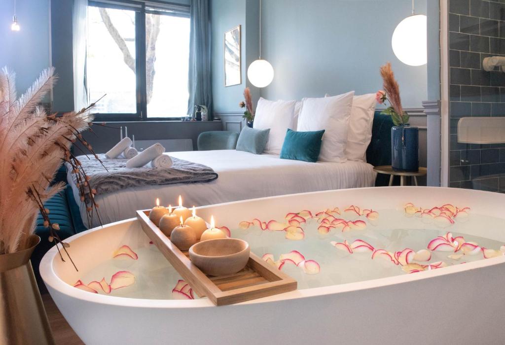 Cette chambre dispose d'une baignoire avec des bougies. dans l'établissement The Parisian Blue Eiffel Tower, à Paris