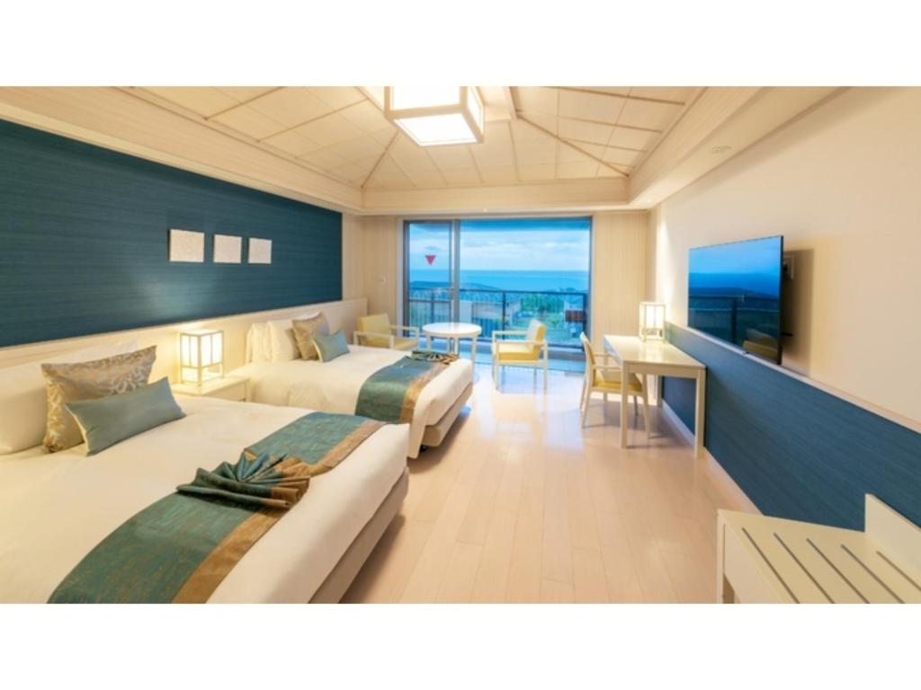 a hotel room with two beds and a dining area at Miyakojima Kurima Resort Seawood Hotel - Vacation STAY 16226v in Uechi