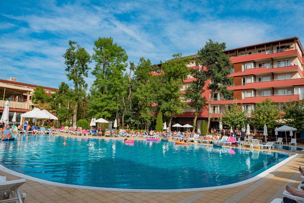 a large swimming pool in front of a hotel at Menada Zornitsa Apartments in Sunny Beach