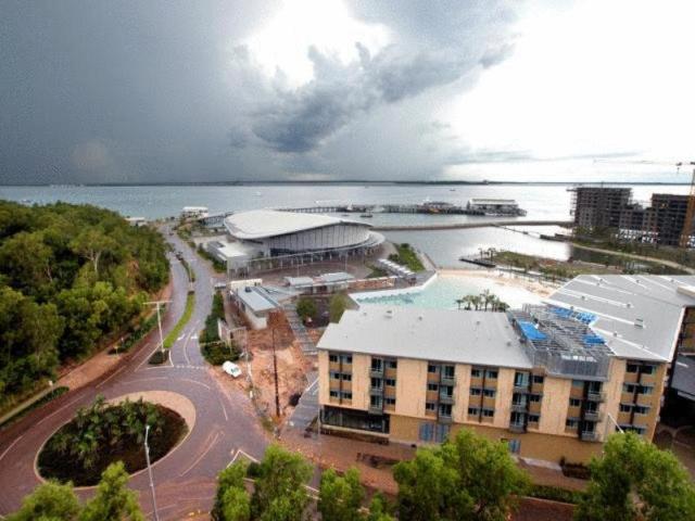 an aerial view of a large building with a lake at Darwin Deluxe Apartments in Darwin