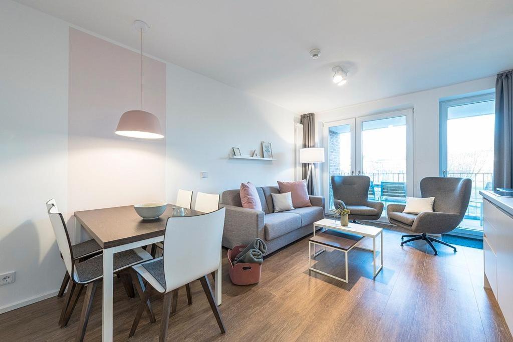 a living room with a table and a couch at Apartmentvilla Anna See Apartmentvilla Anna See 2-12 in Langeoog