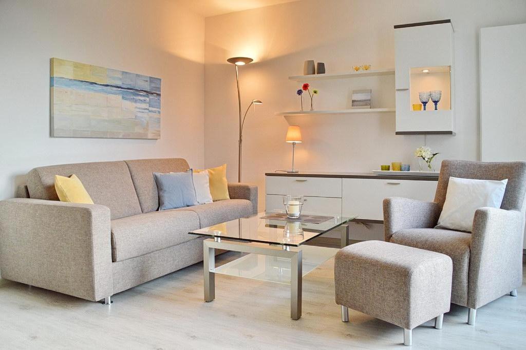 a living room with a couch and two chairs and a table at Residenz Seestern Residenz Seestern 2-31 in Boltenhagen