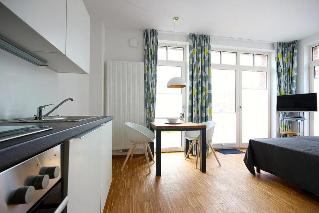 a kitchen with a sink and a table in a room at Ferienvillen Anna Düne Ferienvillen Anna Düne 1-03 in Wangerooge