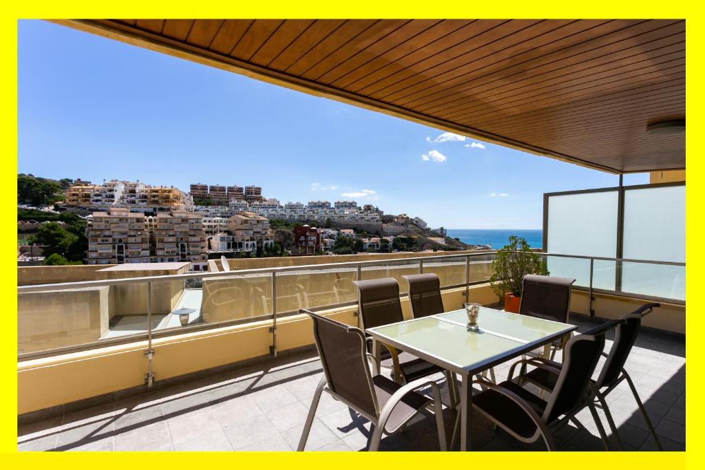 a table and chairs on a balcony with a view at Big Terrace Apartment Cullera in Cullera