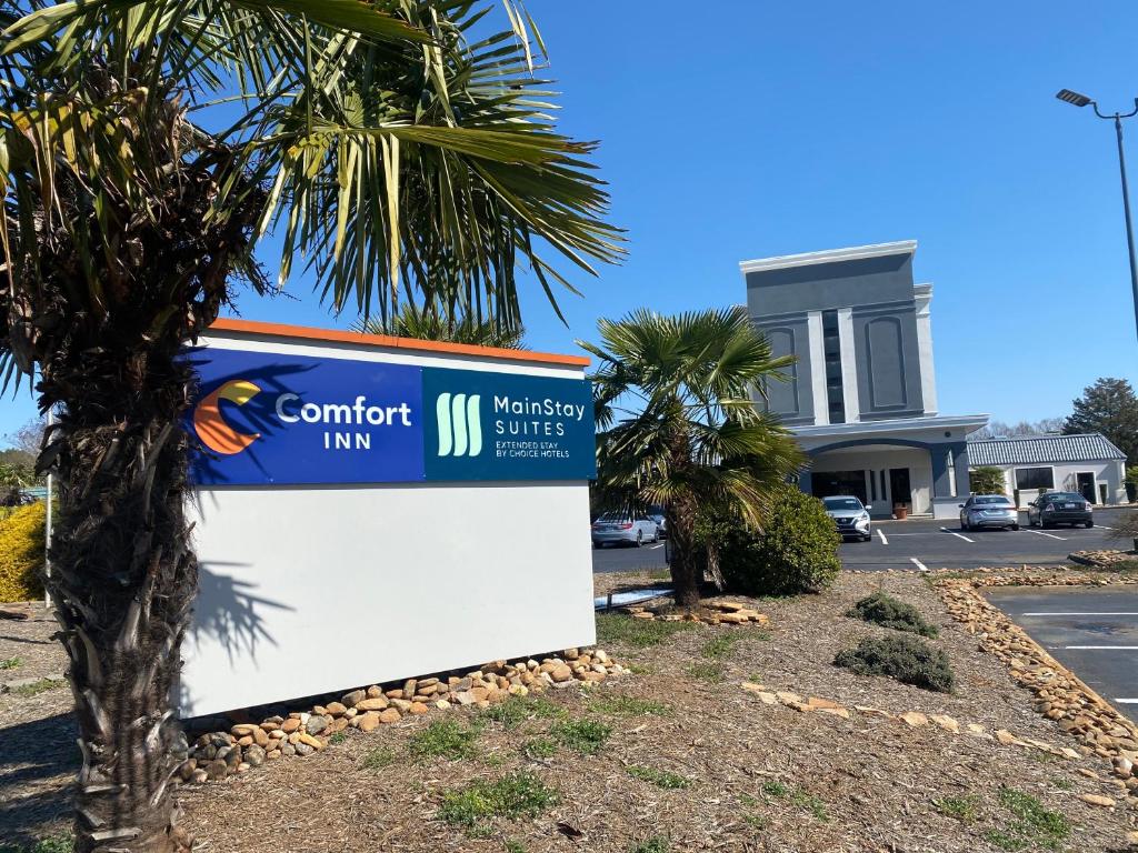 a sign in front of a building with a palm tree at Comfort Inn Conover-Hickory in Conover