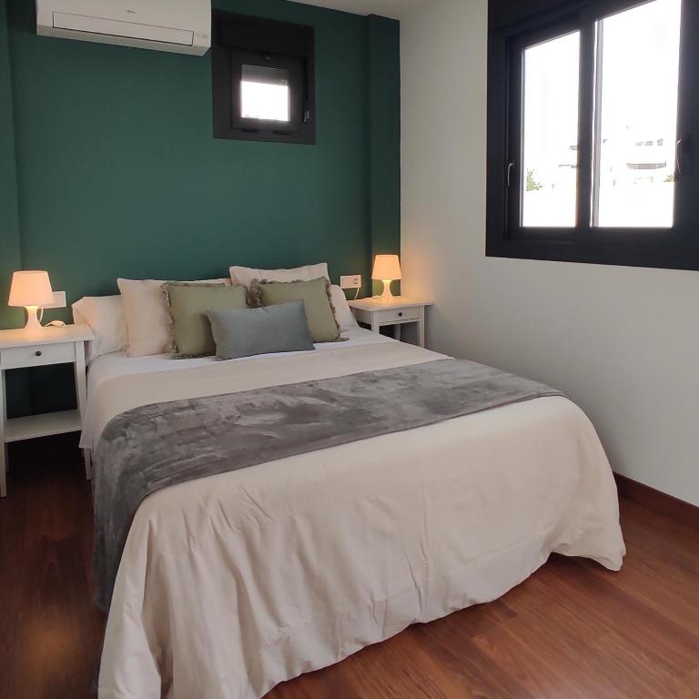 Posteľ alebo postele v izbe v ubytovaní Apartamentos LOS GATA GATA
