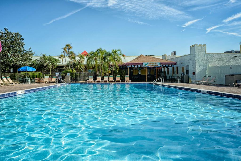 
a large swimming pool with a blue sky at Seralago Hotel & Suites Main Gate East in Orlando
