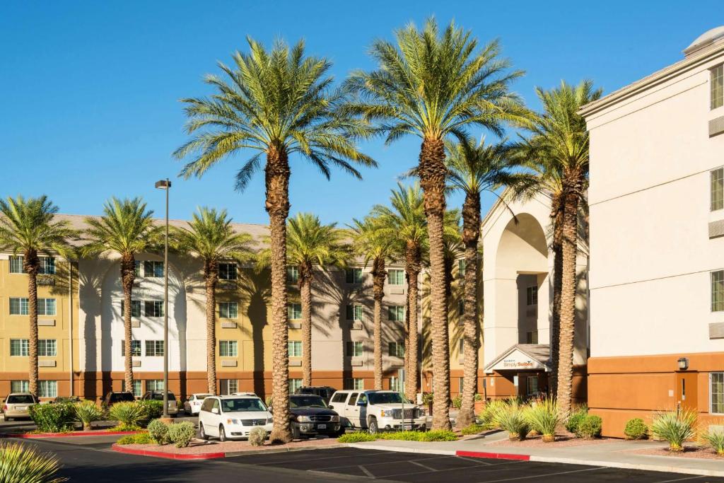 a parking lot with palm trees in front of a building at Sonesta Simply Suites Las Vegas Convention Center in Las Vegas