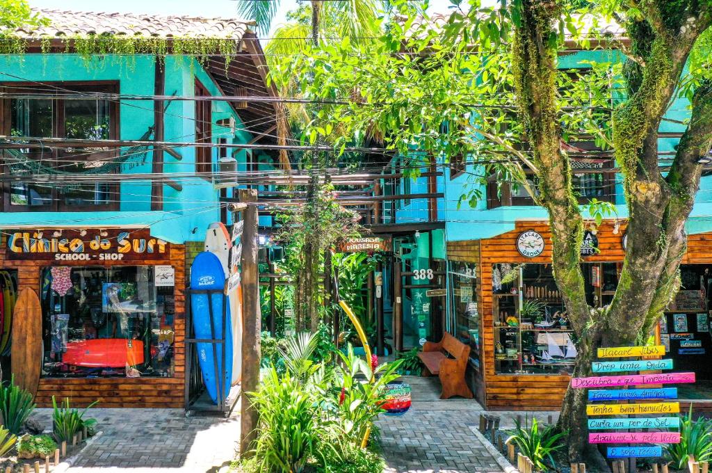 a store with a surfboard in front of a building at Pousada Maresia in Itacaré