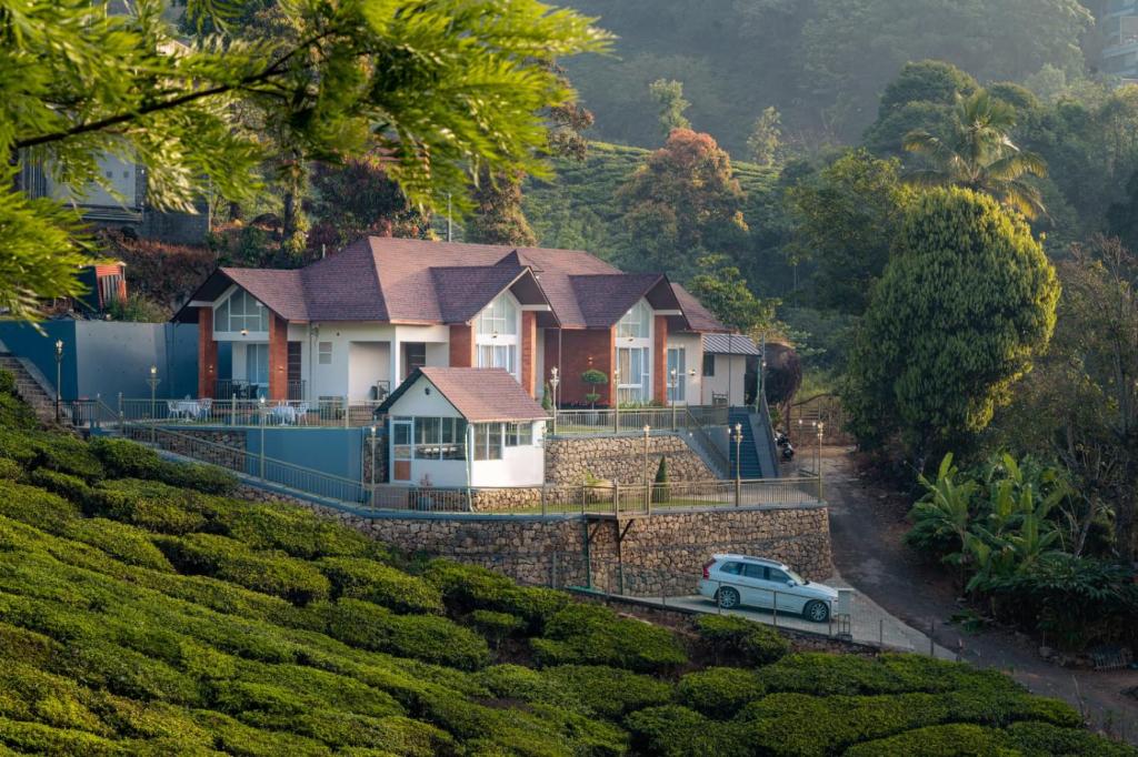 a white truck parked in front of a house at THRILL HOLIDAYS MUNNAR in Anachal