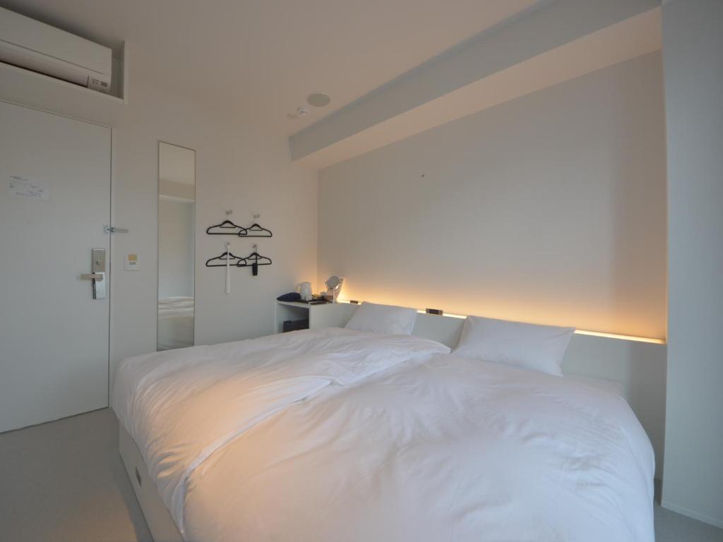 Postel nebo postele na pokoji v ubytování Carta Hotel Kyoto Gion